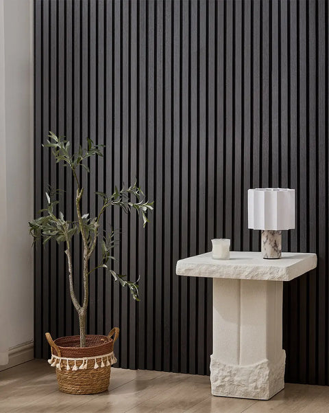Black NORDAN acoustic slat wood wall panels installed as a feature wall in a styled interior space.