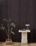Dark Walnut NORDAN acoustic slat wood wall panels installed as a feature wall in a styled interior space.