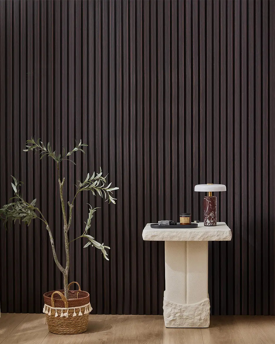 Dark Walnut NORDAN acoustic slat wood wall panels installed as a feature wall in a styled interior space.