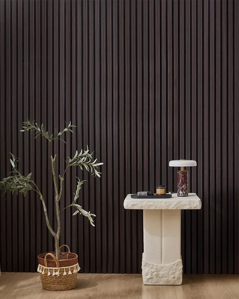 Dark Walnut NORDAN acoustic slat wood wall panels installed as a feature wall in a styled interior space.