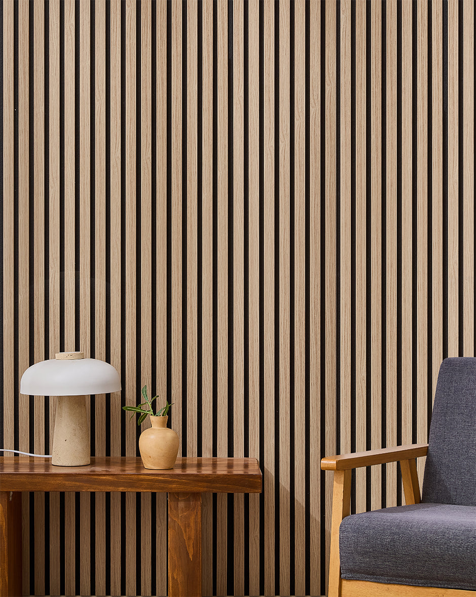 Oak NORDAN acoustic slat wood wall panels installed as a feature wall in a reading corner.