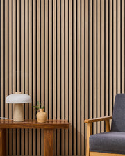 Oak NORDAN acoustic slat wood wall panels installed as a feature wall in a reading corner.