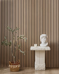 Oak NORDAN acoustic slat wood wall panels installed as a feature wall in a styled interior space.