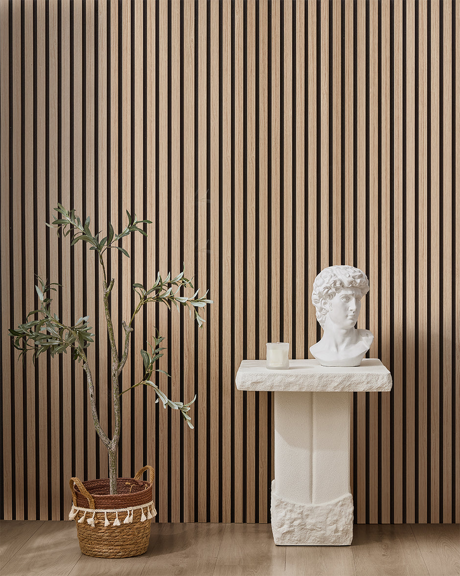 Oak NORDAN acoustic slat wood wall panels installed as a feature wall in a styled interior space.