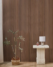 Teak NORDAN acoustic slat wood wall panels installed as a feature wall in a styled interior space.