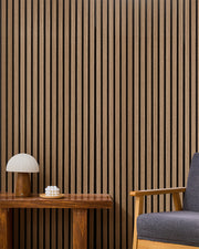 Walnut NORDAN acoustic slat wood wall panels installed as a feature wall in a reading corner.