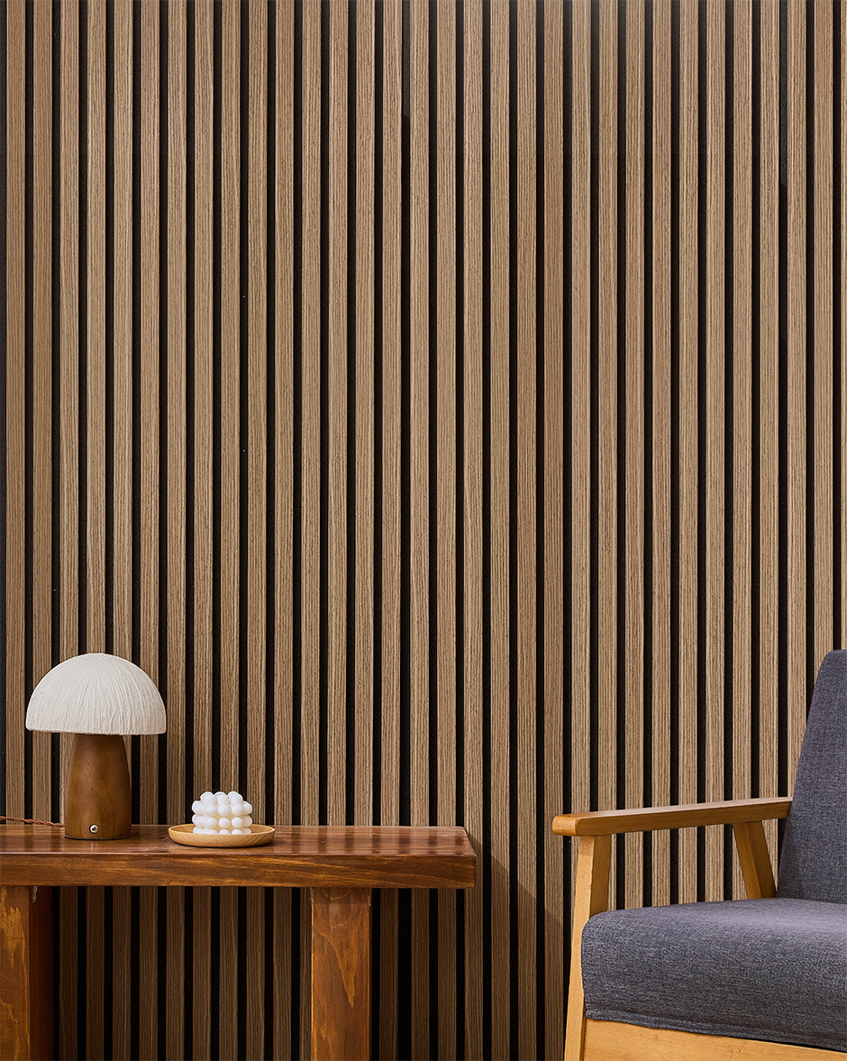 Walnut NORDAN acoustic slat wood wall panels installed as a feature wall in a reading corner.