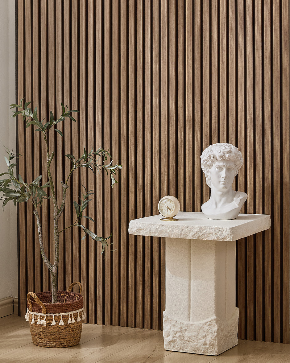 Walnut NORDAN acoustic slat wood wall panels installed as a feature wall in a styled interior space.