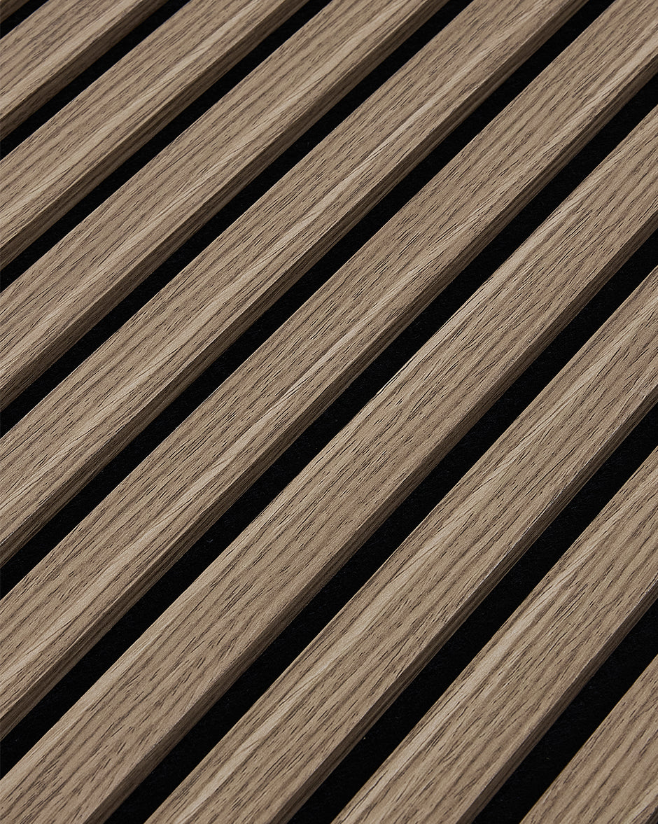 Close-up of the walnut woodgrain finish and vertical slat texture on NORDAN acoustic wall panels.